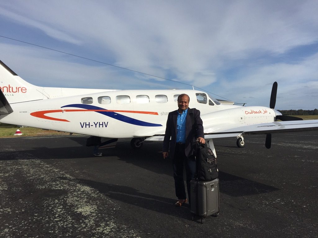Sohail Hasnie beside a charter aircraft on a regional airstrip